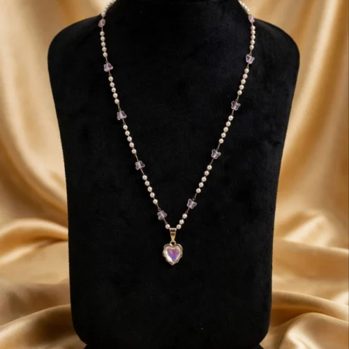 Faux pearl and lilac glass butterfly bead necklace with iridescent heart pendant on black velvet bust