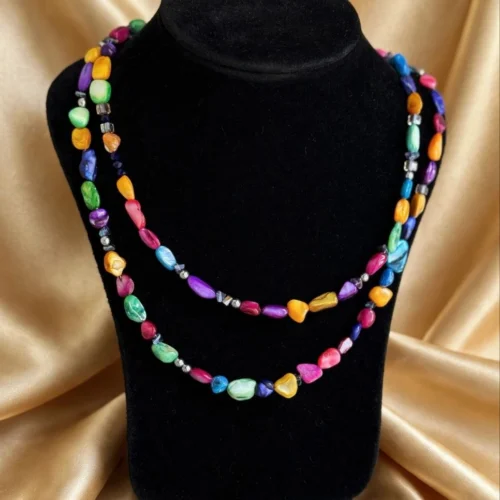 Double-strand necklace of multicolour shell-look nugget beads on black velvet bust