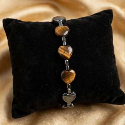 Tiger-eye-look heart bead bracelet with hematite-look cube spacers displayed on black velvet pillow