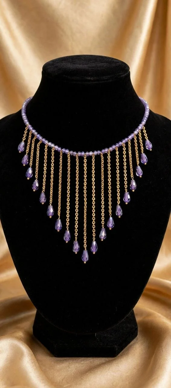 Lavender crystal bead necklace with gold-tone chain fringe and purple crystal teardrops on black velvet bust