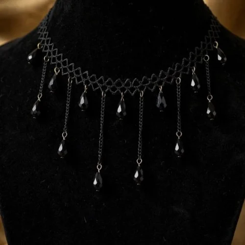 Black lattice choker with chain fringe and faceted black teardrop beads on black velvet bust