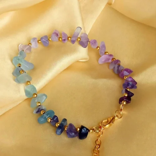 Fluorite-look aqua, lilac and purple stone chip bracelet with gold-tone beads and lobster clasp on yellow satin