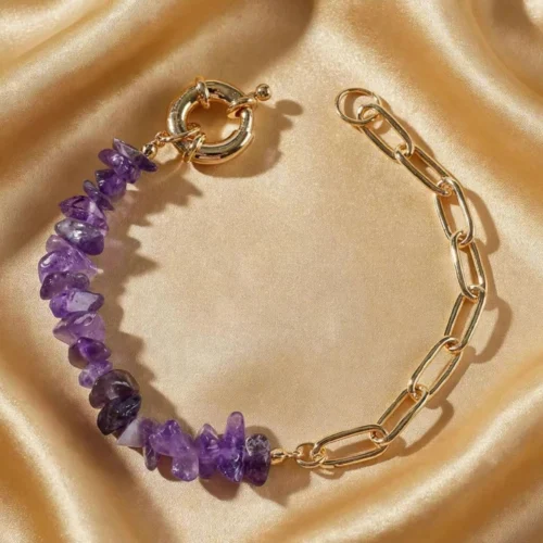 Purple amethyst-colour stone chip bracelet with gold-tone paperclip chain and round spring clasp on gold satin